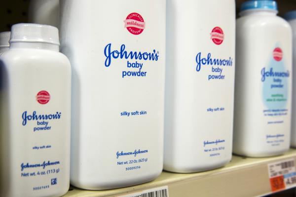 Bottles of Johnson & Johnson baby powder line a drugstore shelf in New York