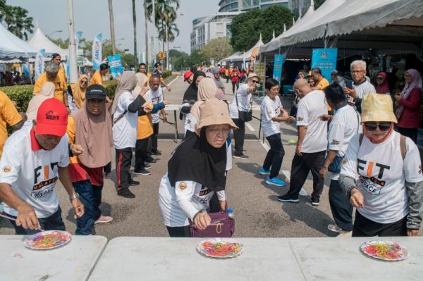 Senior citizens taking part in a rubber band relay on Natio<em></em>nal Sports Day 2023 at Dataran Putrajaya. — Picture by Shafwan Zaidon